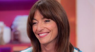 Davina McCall stuns in a tiny pink bikini as she shows off her abs